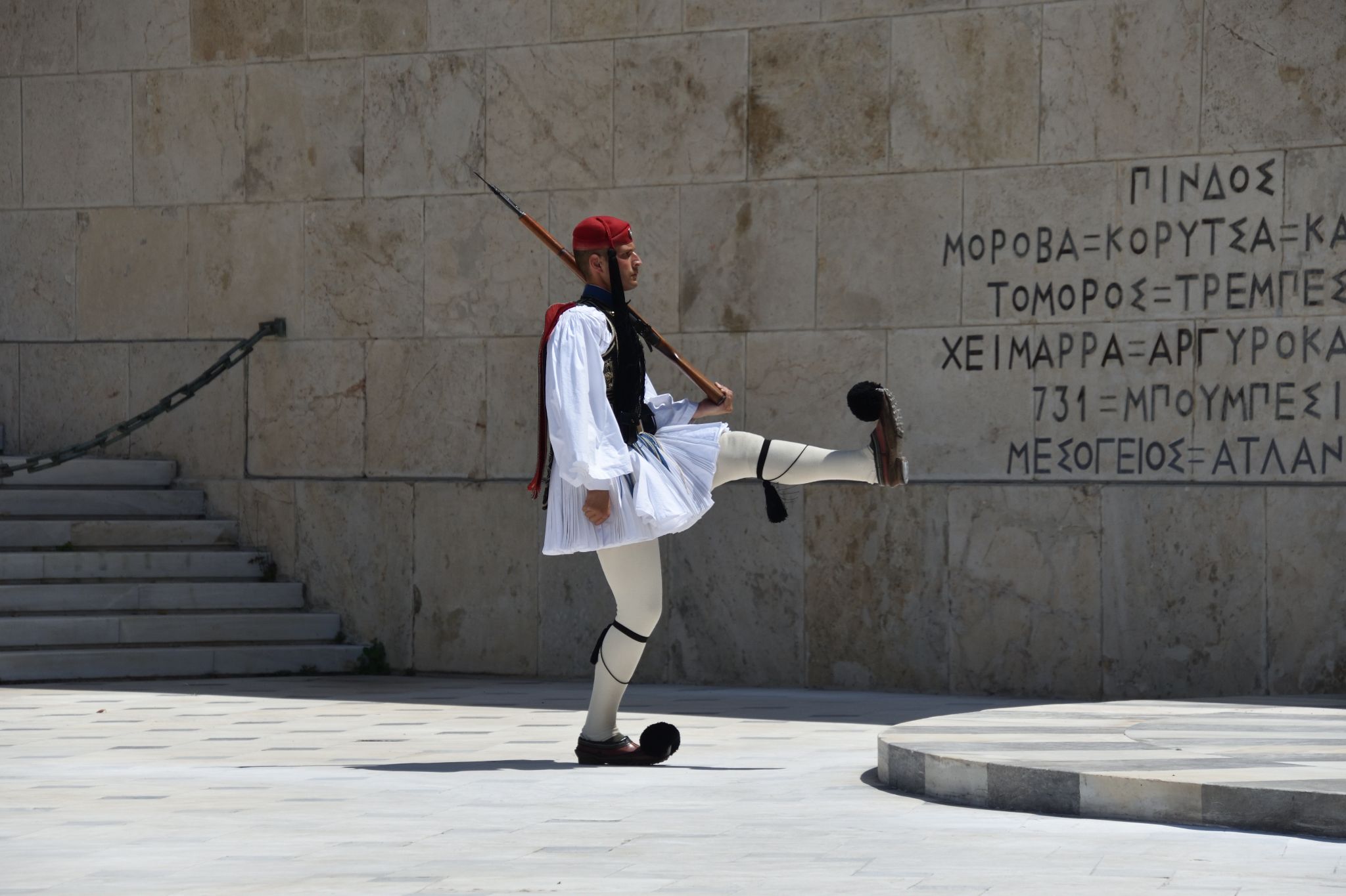 Greek national guards (Evzones) in front of the Tomb of the Unknown Soldier near building of Parliament